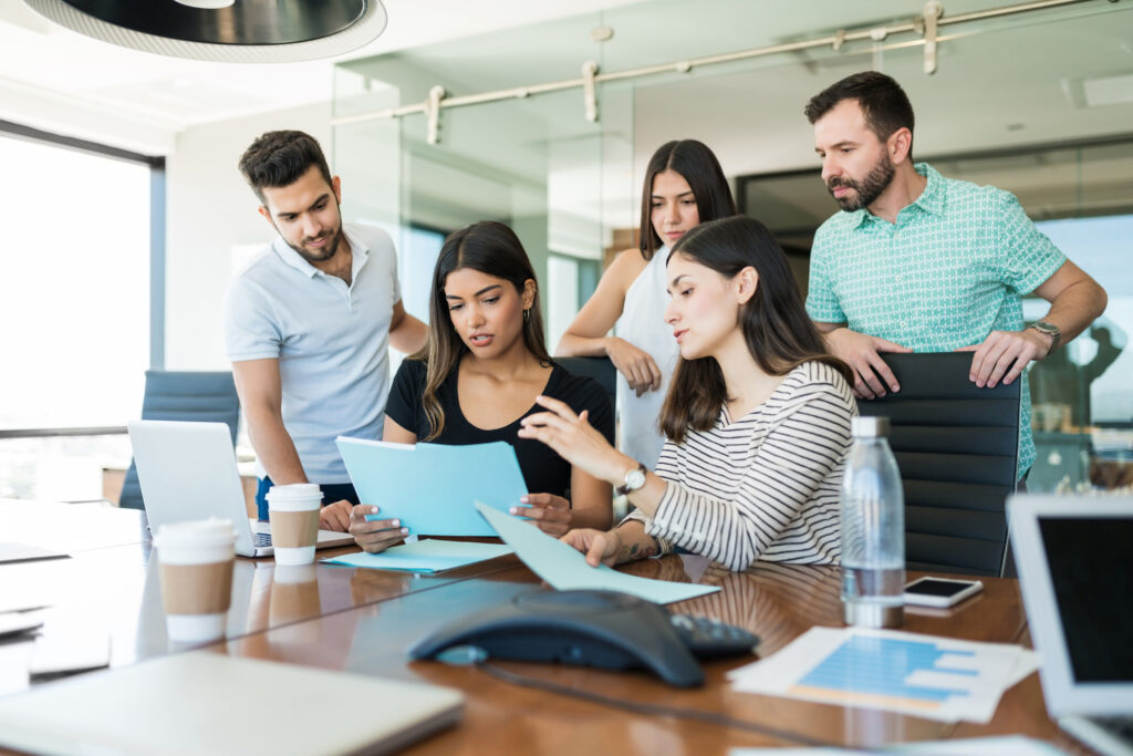 Team Business Professionals Discussing File Desk Creative Office Meeting 1 1024x683