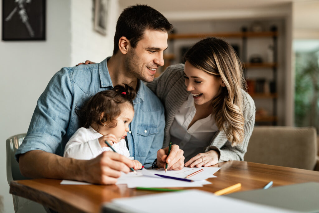 Young Happy Parents Enjoying Coloring With Their Small Daughter Home 1 1024x683